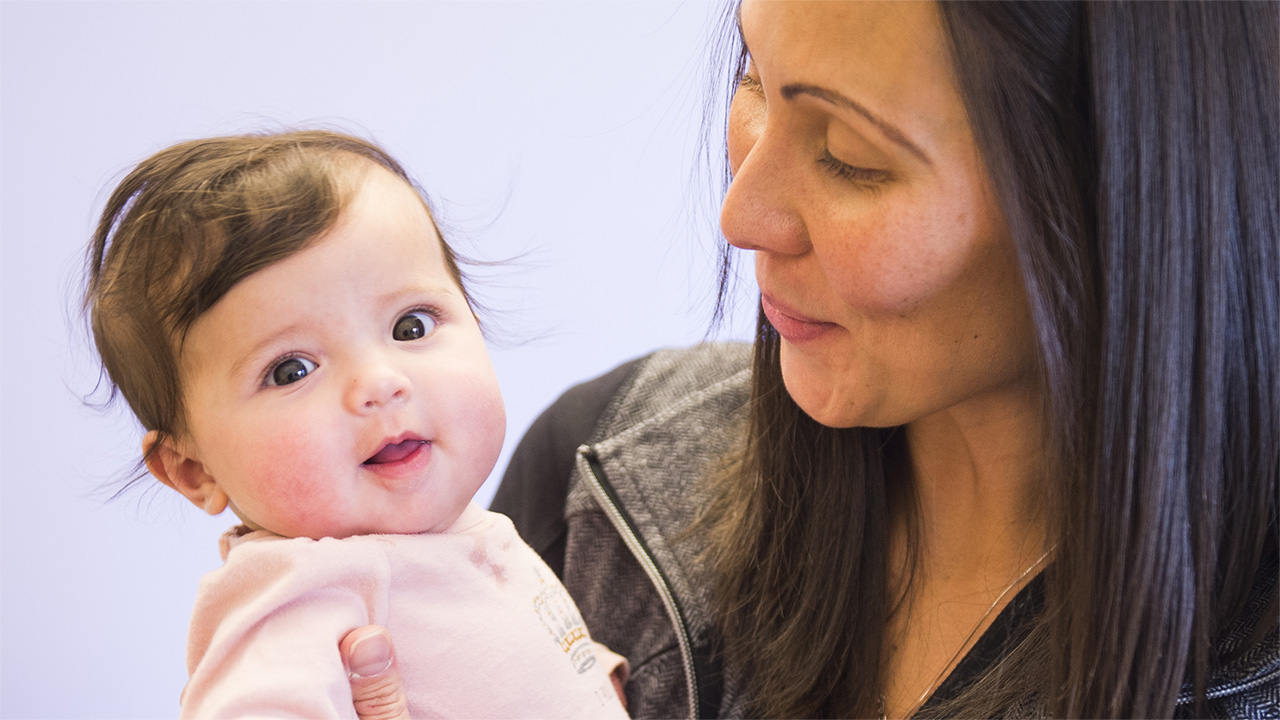 Photo of a mother looking at her infant child.